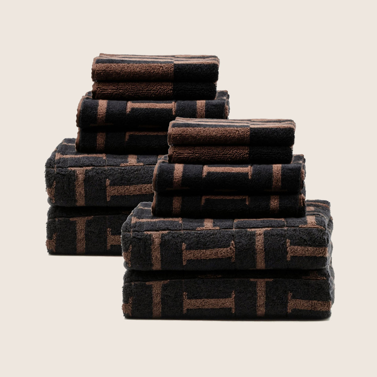 Stack of folded cotton towels, tobacco brown and black plaid stripe pattern