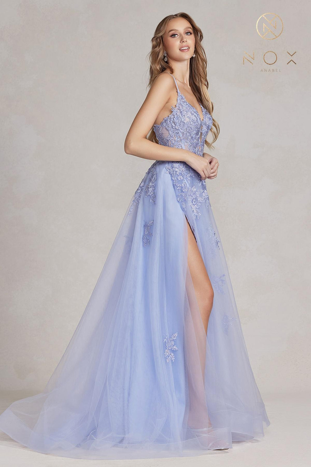 Periwinkle A-line tulle gown with lace appliques, spaghetti straps, front slit