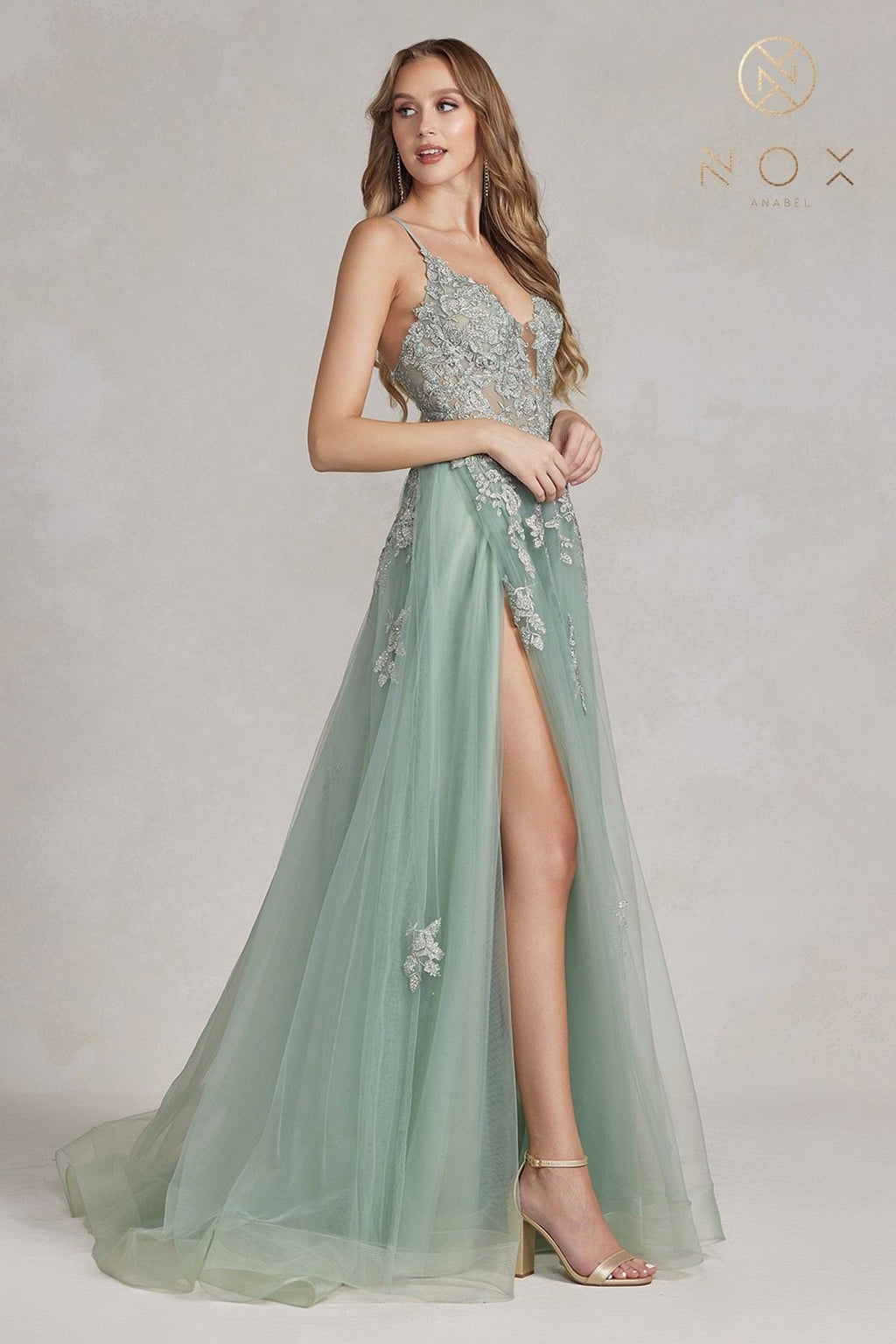 Sage green A-line tulle gown with lace appliques, sweetheart straps, front slit
