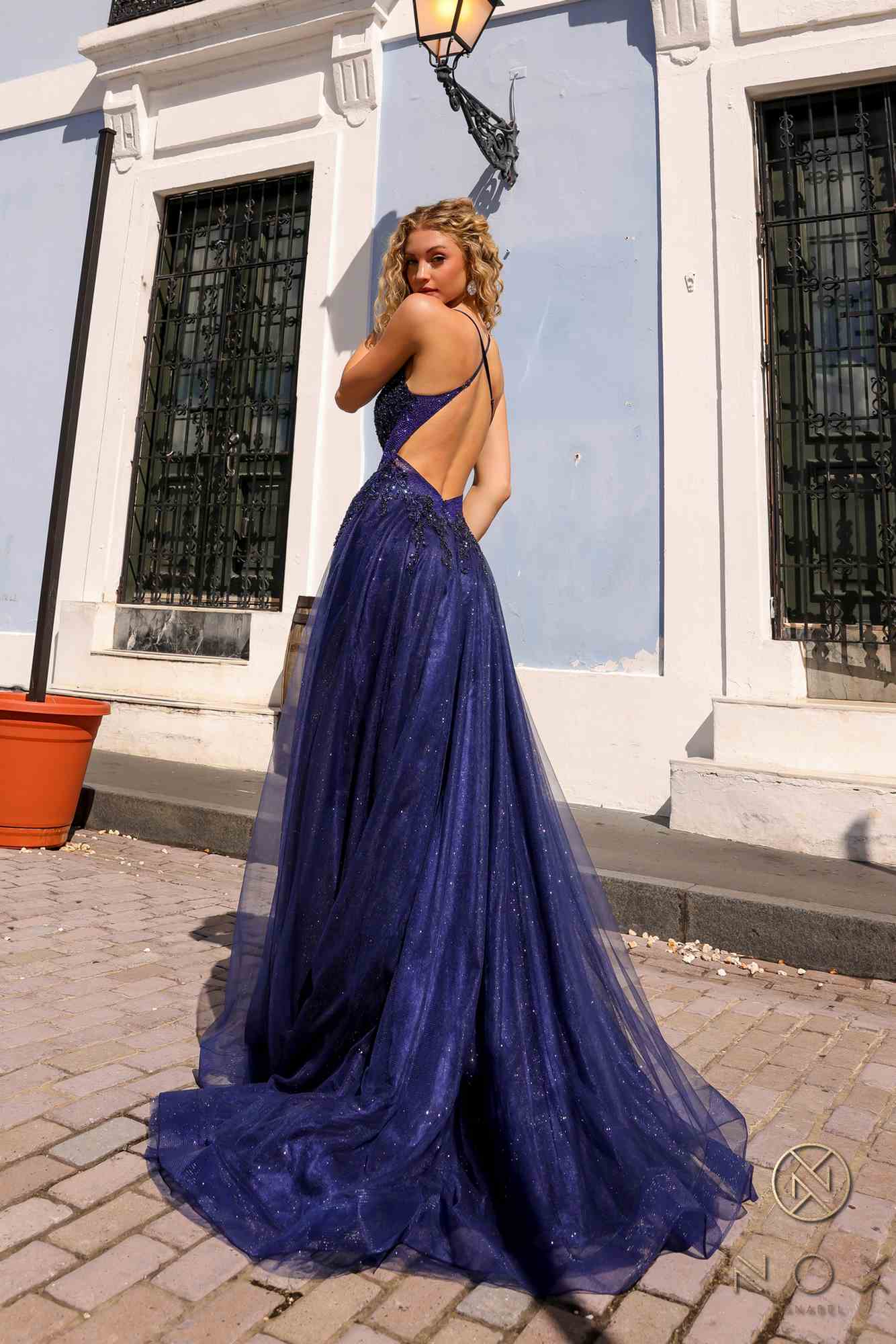 Navy glitter tulle ball gown, open-back straps and floor-length flowing skirt