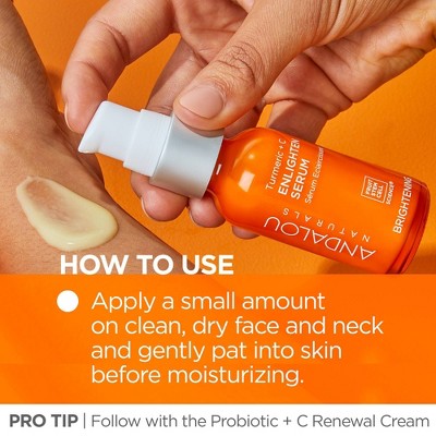 Orange serum bottle with white pump held in hand, shown dispensing