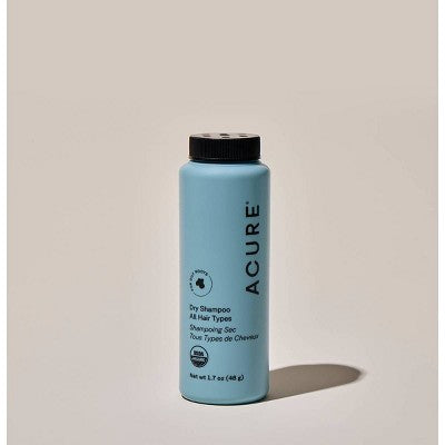 Acure dry shampoo bottle with blue label and black cap, upright view