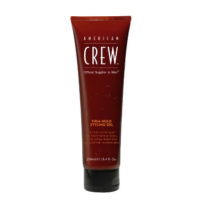 Brown hair styling gel tube standing upright with black base
