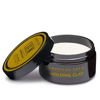 Molding clay jar with black lid opened, label on lid