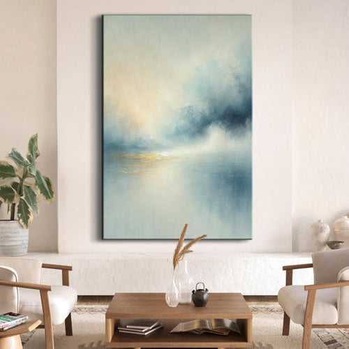 Landscape wall art canvas with cloudy sky in teal, blue, and pale yellow glow