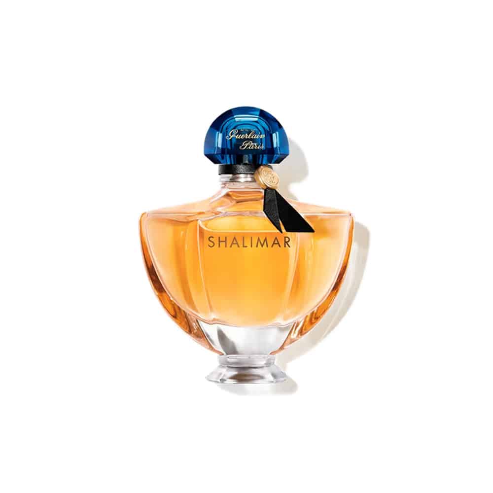 Guerlain Shalimar eau de parfum bottle with amber liquid and blue faceted cap