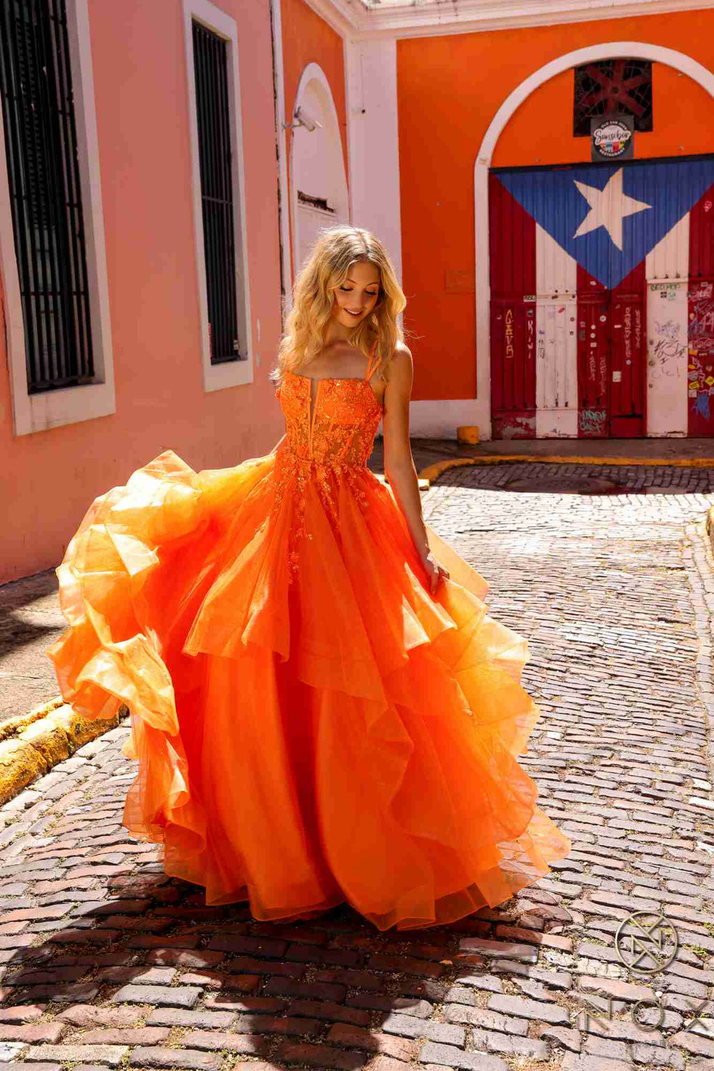 Orange tulle ballgown with layered tiered ruffles and fitted bodice, A-line