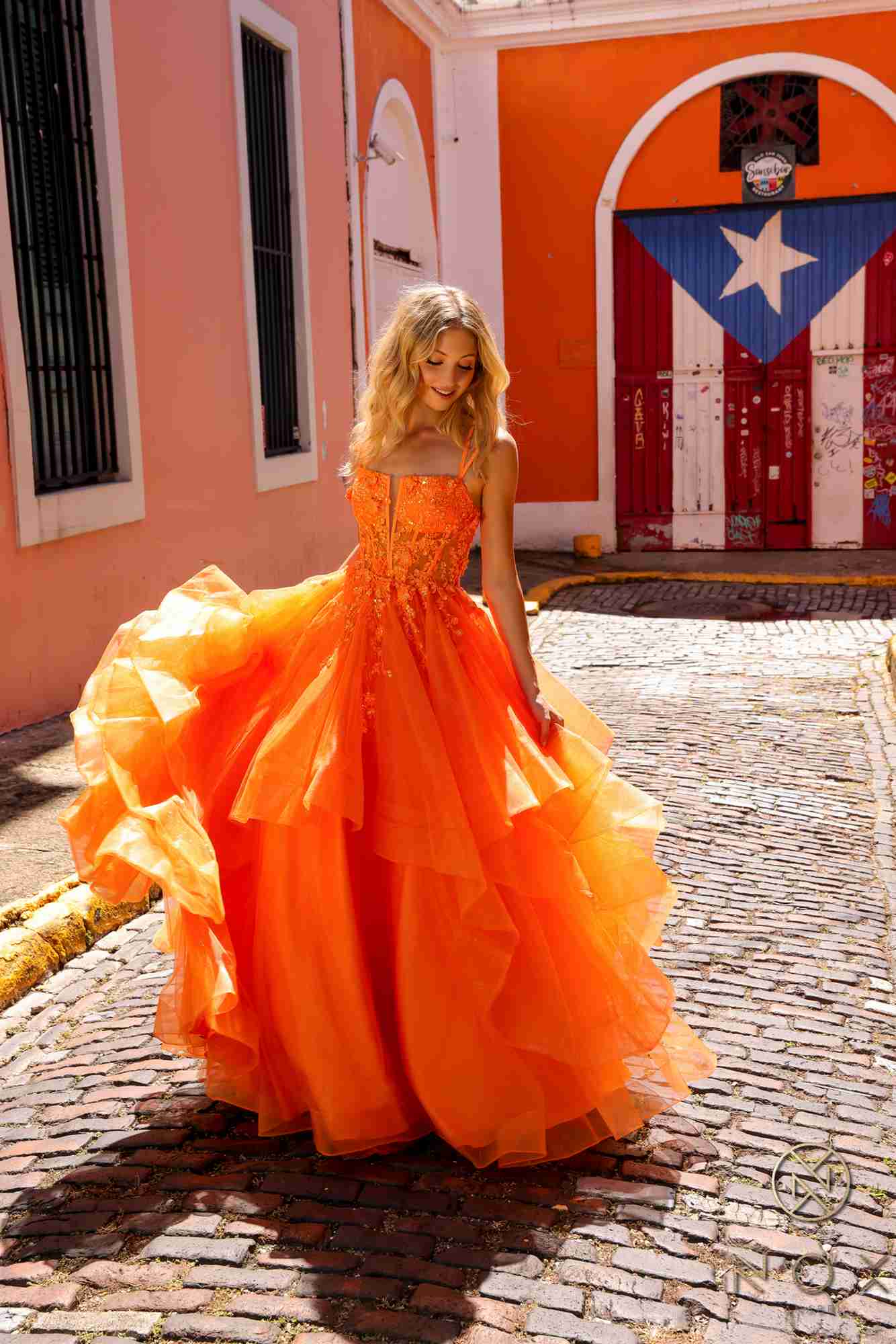 Orange tulle ballgown with layered tiered ruffles and fitted bodice, A-line