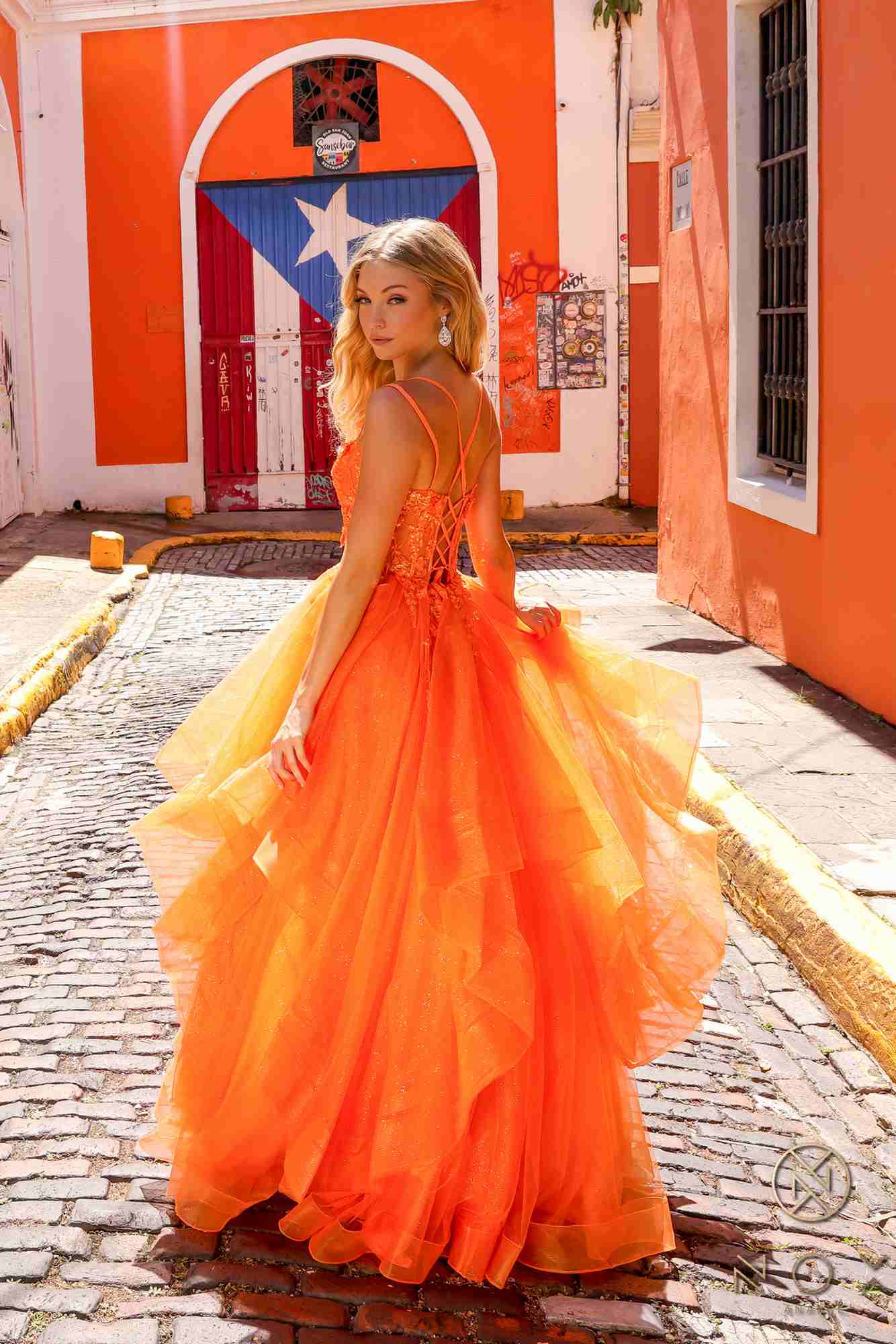 Orange tulle ballgown with layered tiered ruffles and flowing A-line skirt