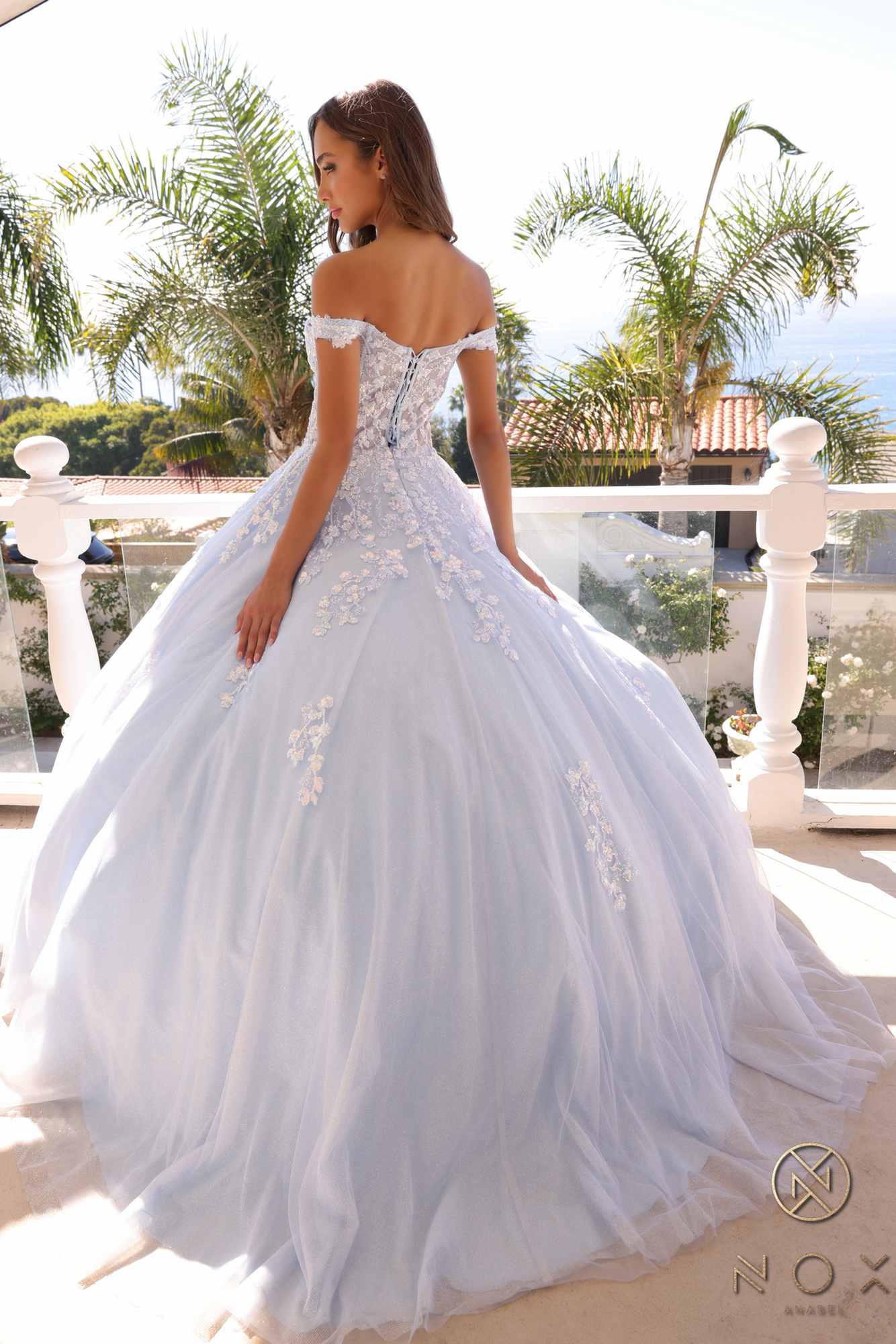 Ivory off-shoulder ballgown with open back lace detailing and full tulle skirt