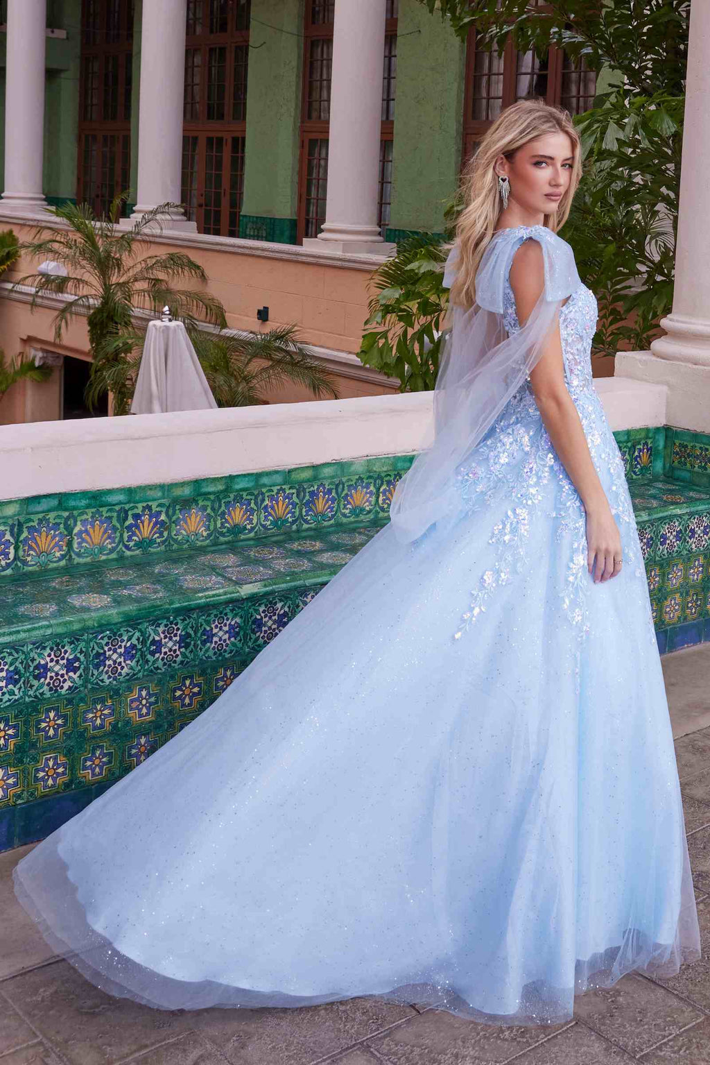 Light blue tulle dress with draped tie-up straps and appliqué bodice, flowing skirt