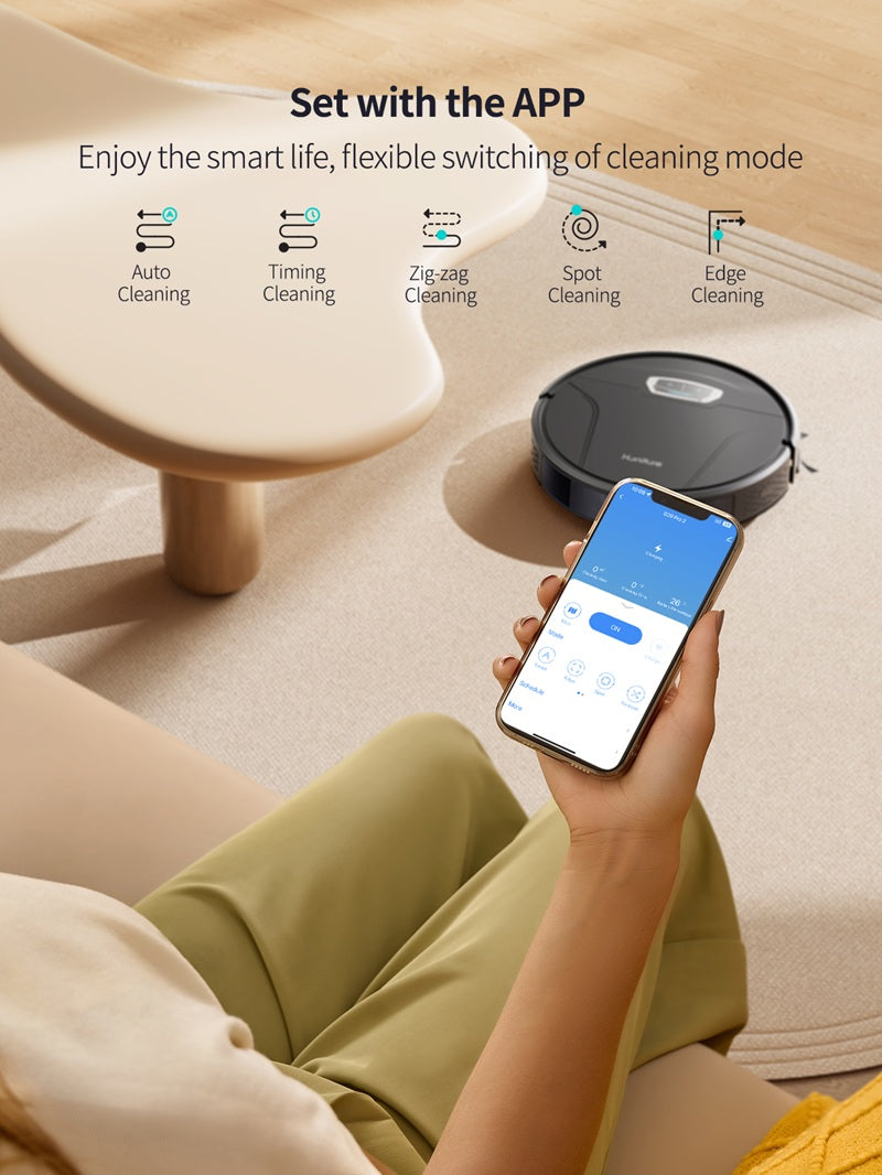 Robotic vacuum next to a smartphone showing cleaning mode controls