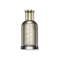 Perfume bottle with silver body, gold cap, and embossed BOSS lettering