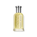 Yellow glass perfume bottle with silver cap and embossed logo.