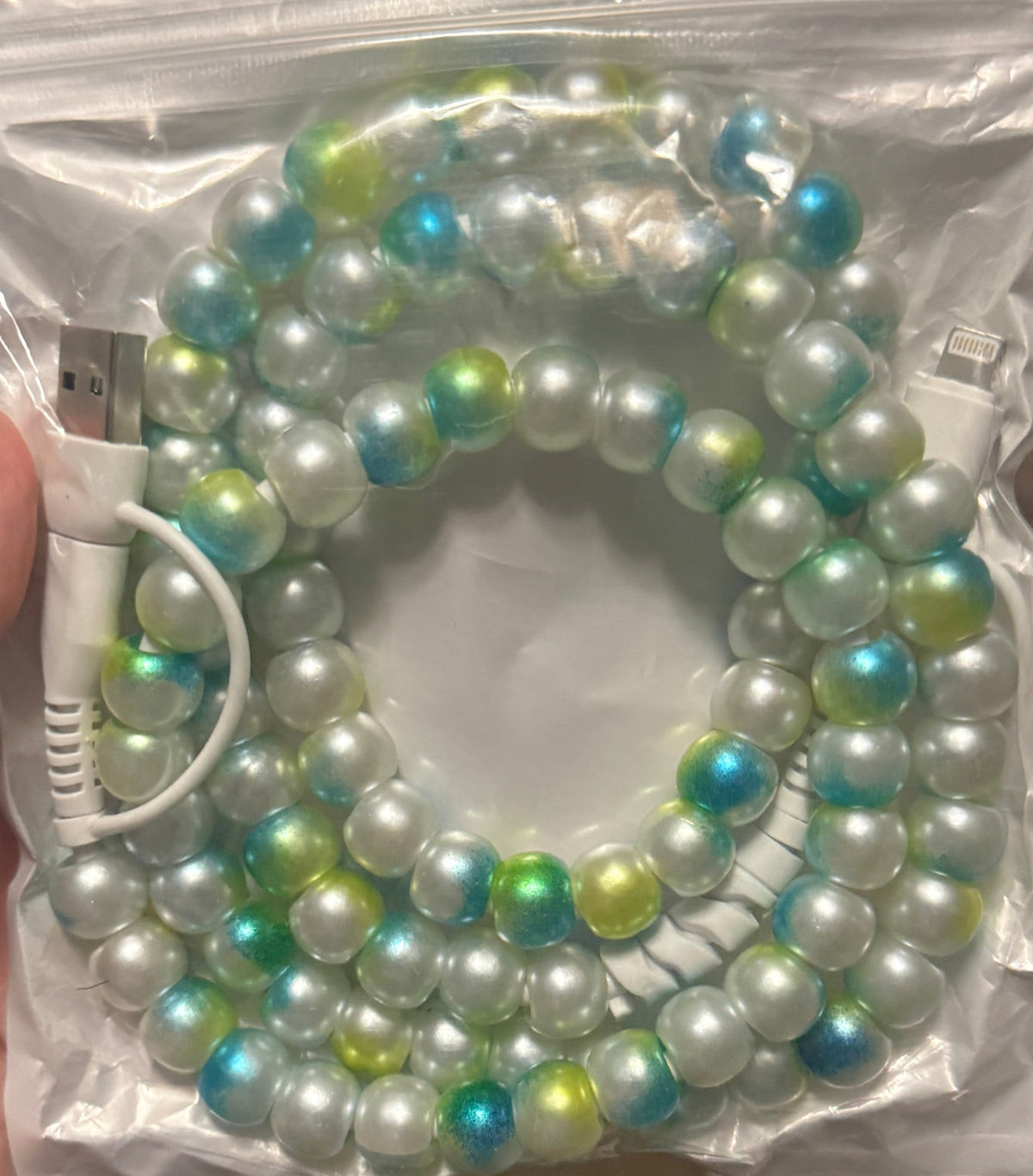 Beaded 4-in-1 charging cable with teal, blue, green, and white iridescent beads, ports shown