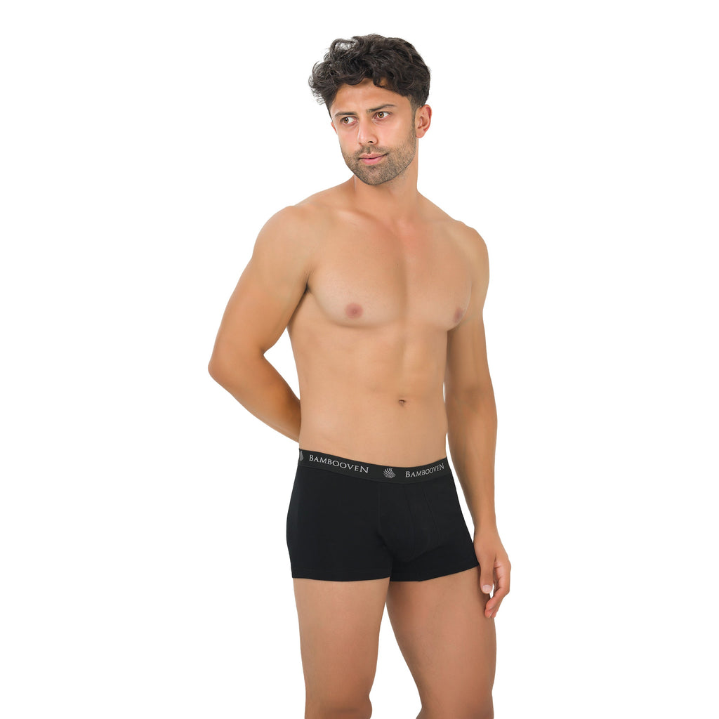 Men's bamboo boxer trunks with logo waistband, black on model, front view