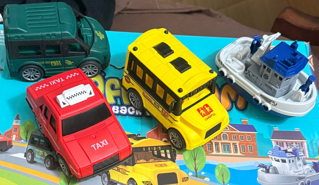 Toy vehicle set tray: red taxi, yellow bus, green van, white boat transport