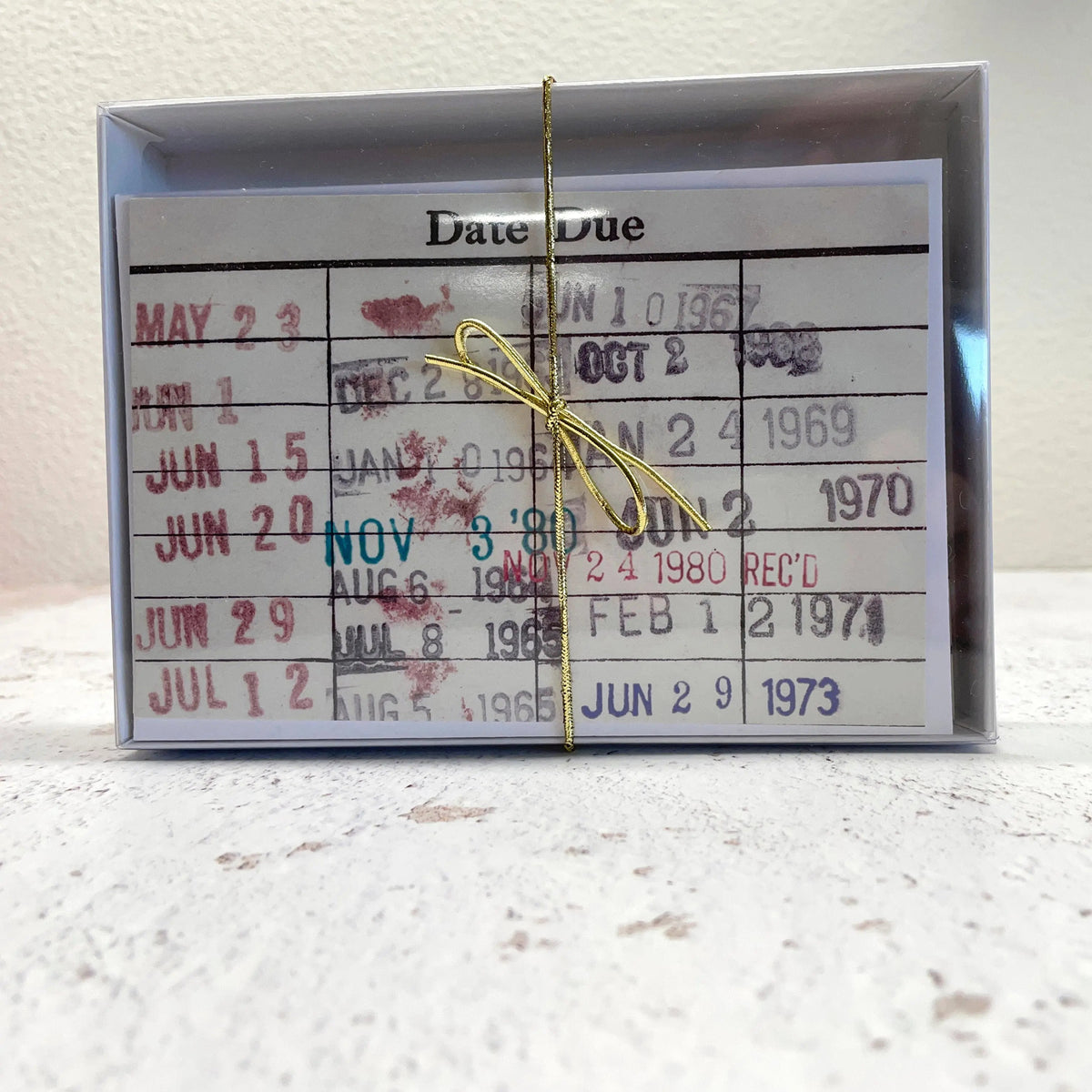 Packaged library due date notecards with 'Date Due' header and red stamped calendar lines