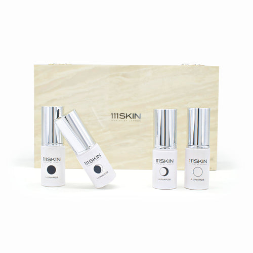 111SKIN Lunar28 skincare set: white bottles with silver caps and small cream tube
