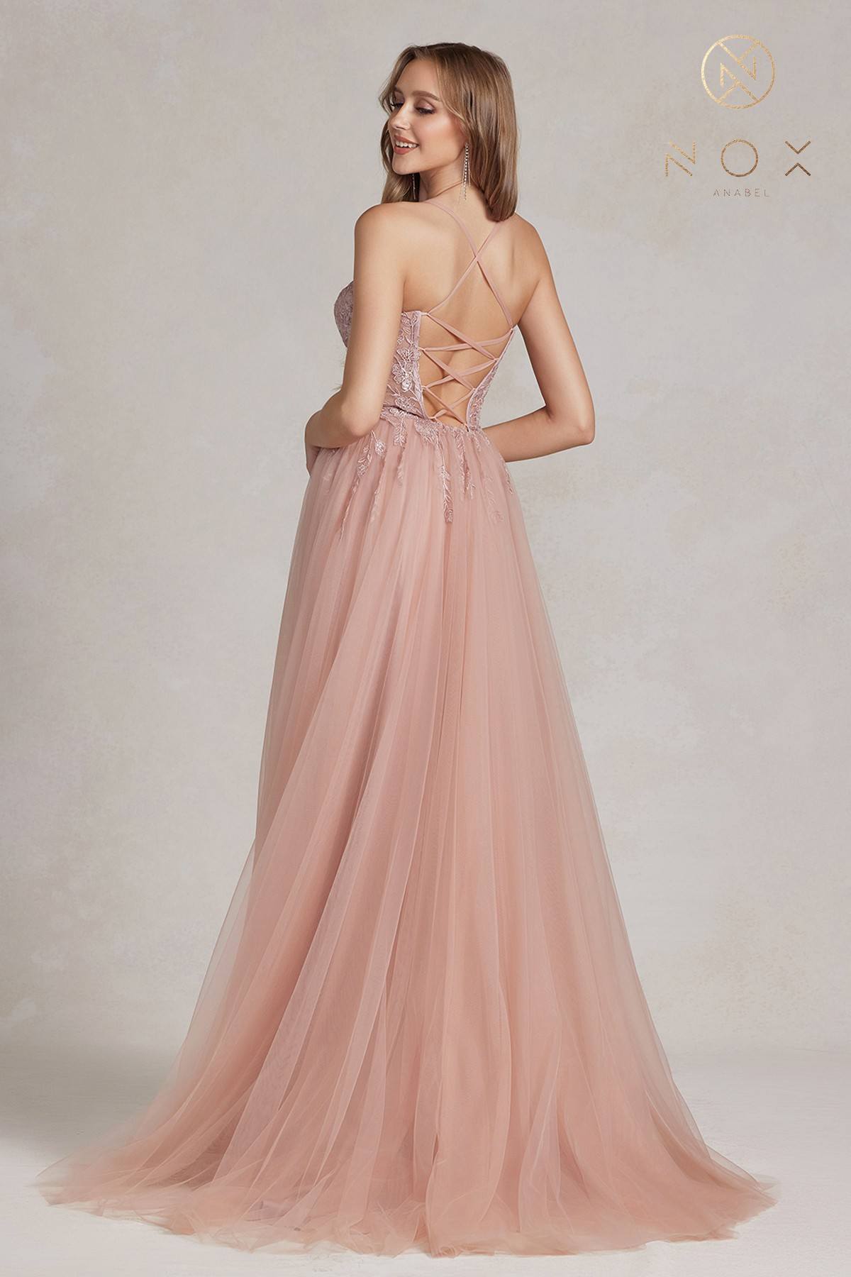 Pink A-line tulle gown with crisscross lace back straps and flowing skirt