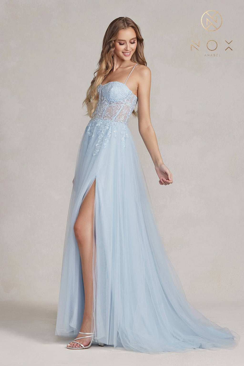 Light blue A-line tulle gown with beaded corset-style bodice and side slit