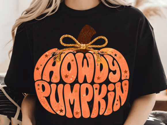 Black pumpkin graphic tee with orange Howdy Pumpkin lettering and bow