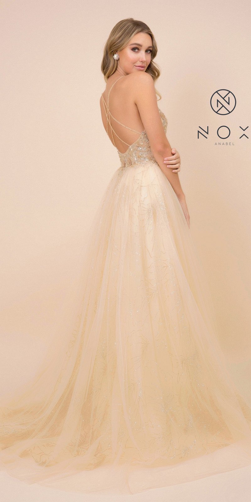 Embellished ball gown in gold with crisscross open back and flowing tulle skirt