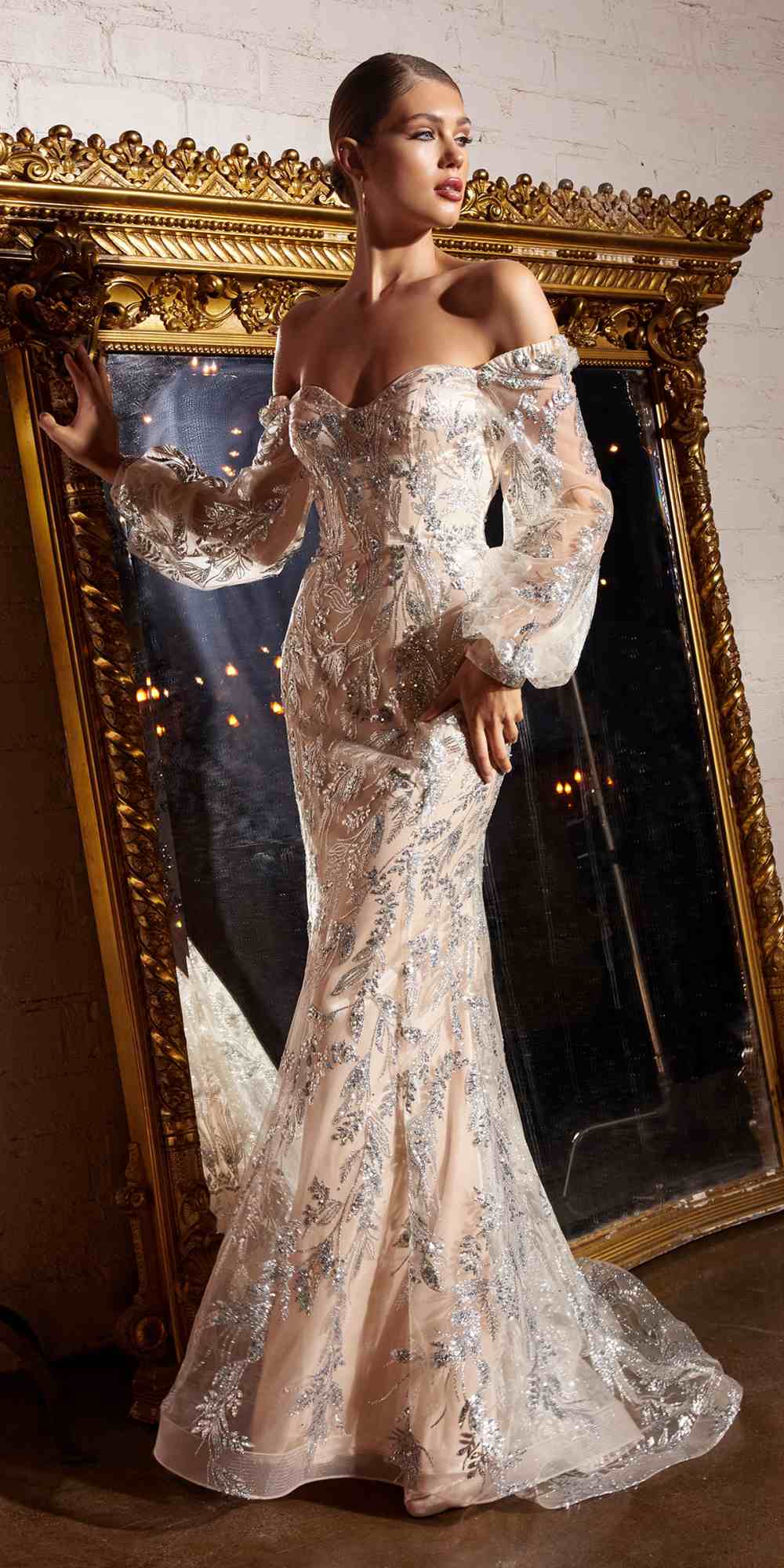 Metallic off-shoulder sequin gown with long removable sleeves, fitted mermaid silhouette.