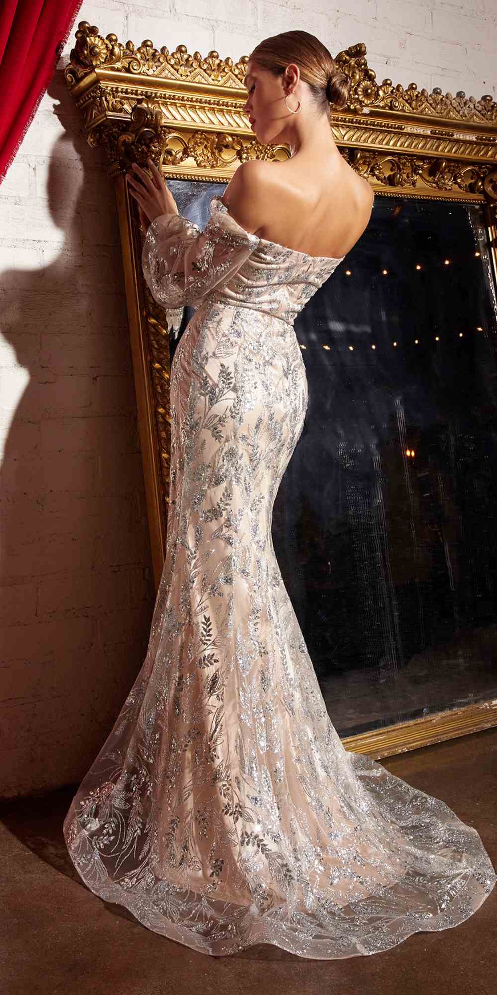 Metallic off-shoulder sequin gown with long sleeves, fitted mermaid silhouette in profile view.