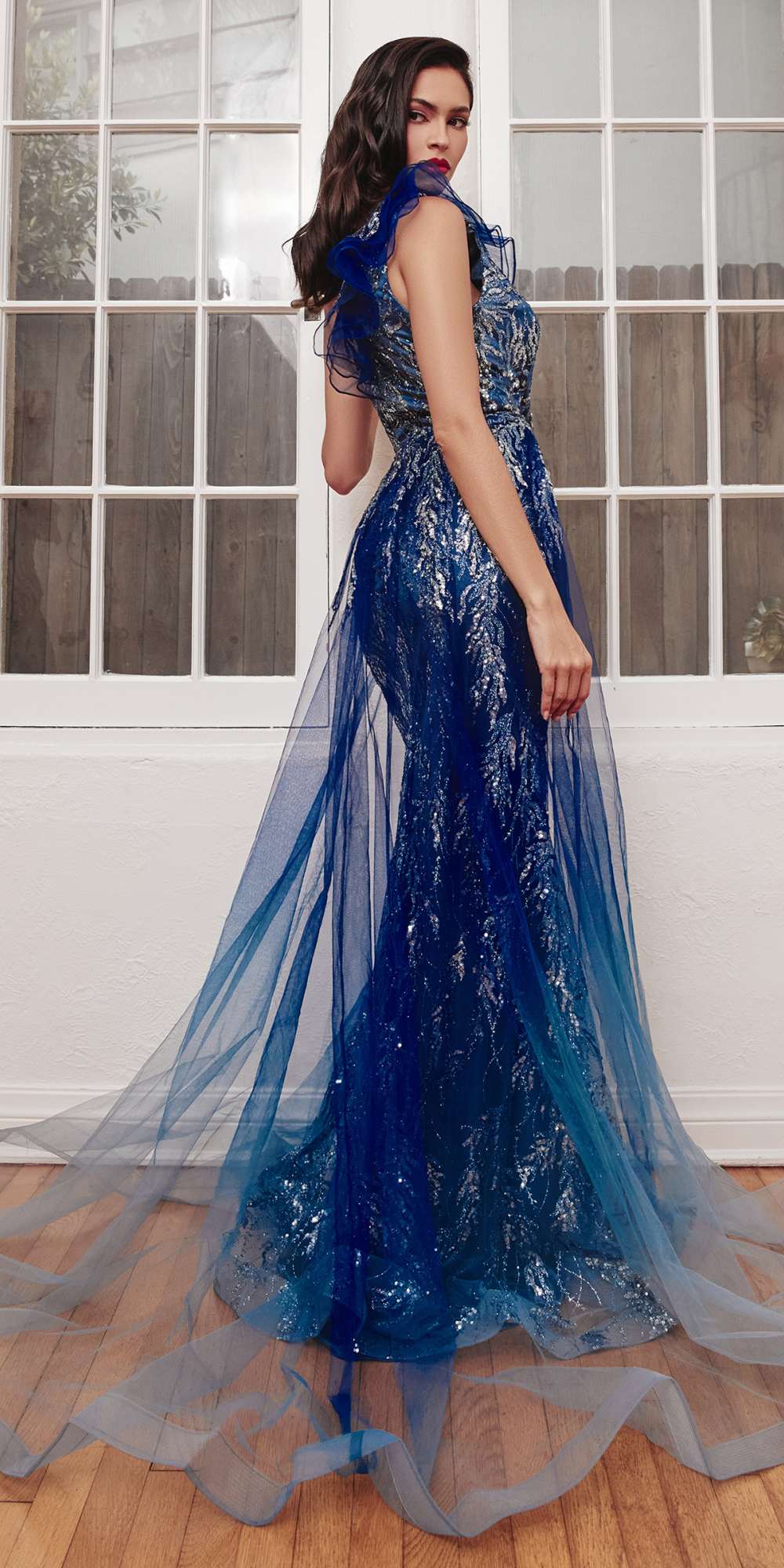 Navy one-shoulder floor-length gown with textured bodice and flowing tulle overskirt, slit