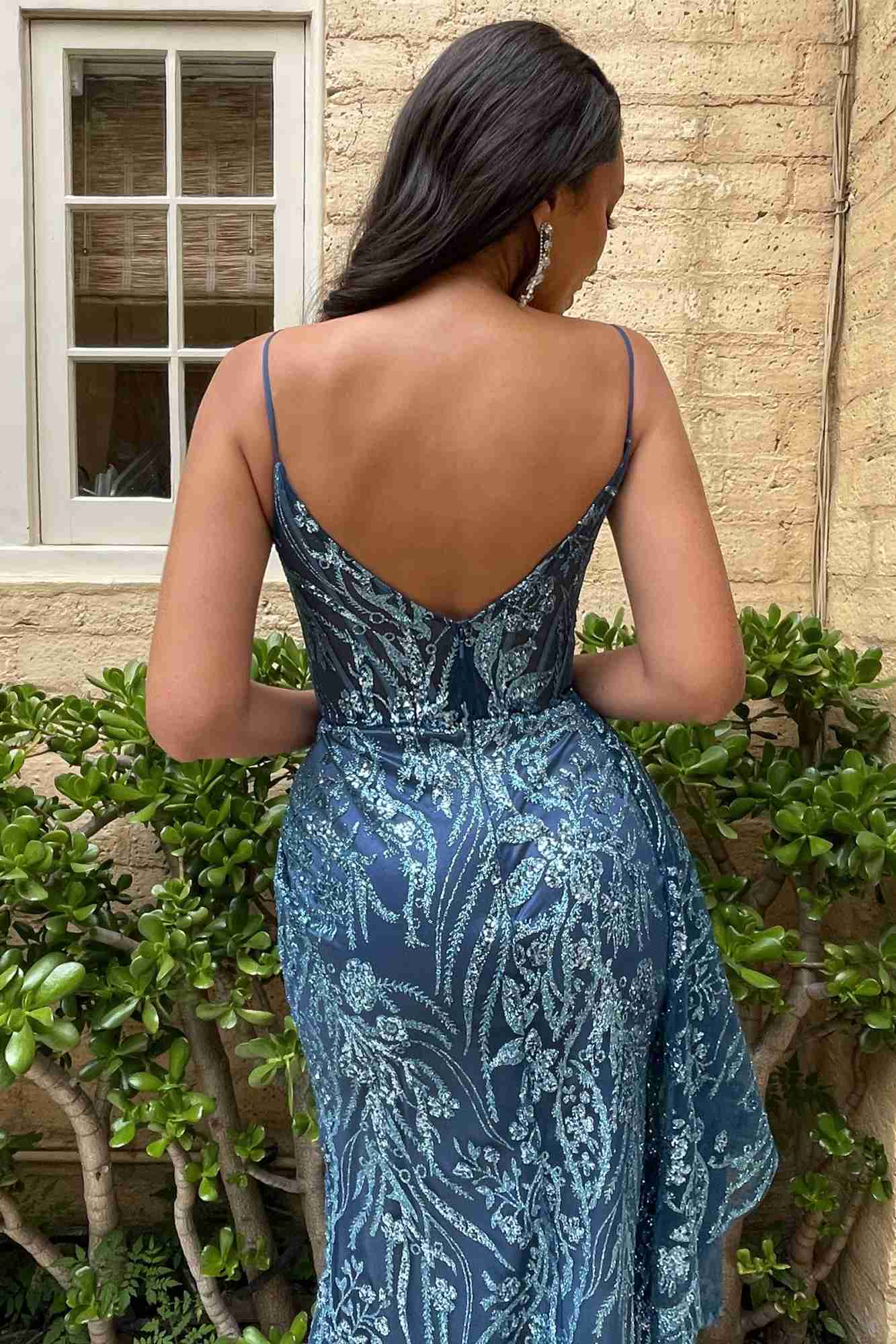 Blue glitter print gown with low open back and fitted waist, floor-length flare