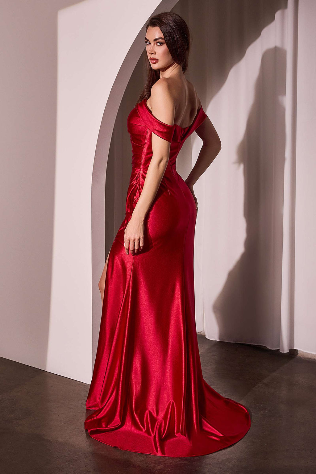 Red off-shoulder satin gown with fitted bodice and draped mermaid skirt