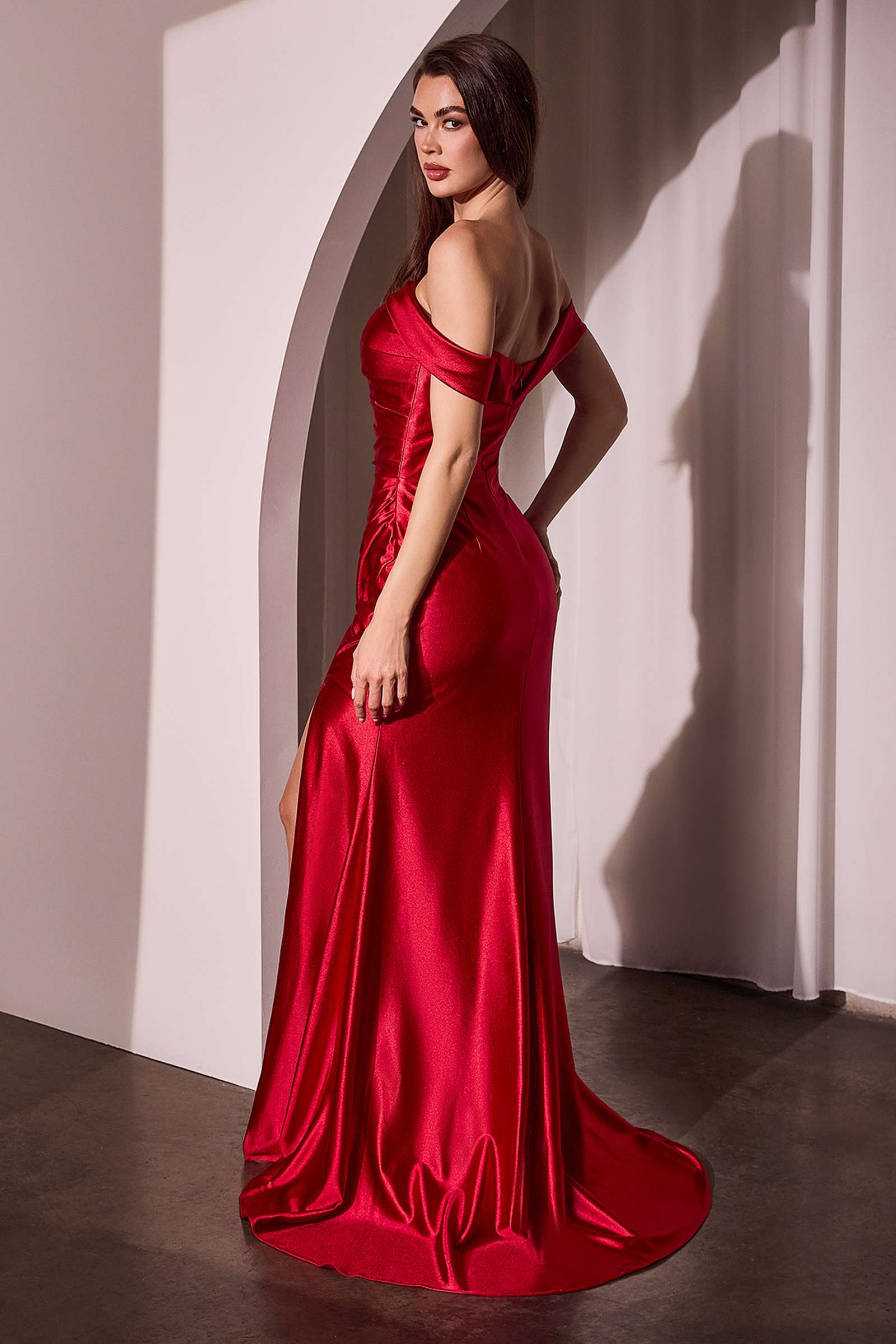 Red off-shoulder satin gown with fitted bodice and draped mermaid skirt