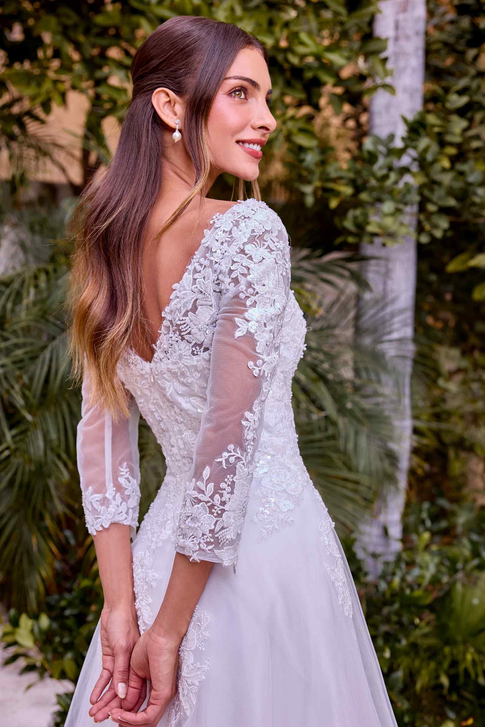 Off-white wedding A-line gown with long lace sleeves and lace appliqué back detail