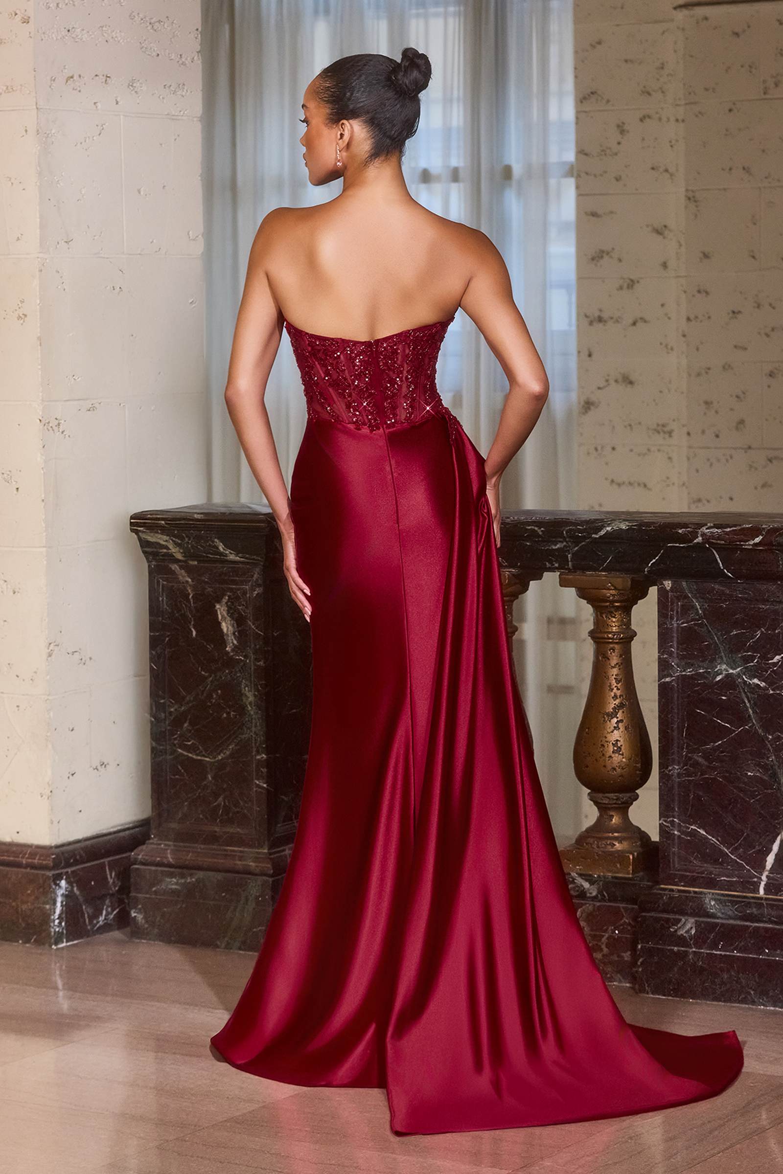 Burgundy strapless evening gown with draped satin skirt and open back, floor length