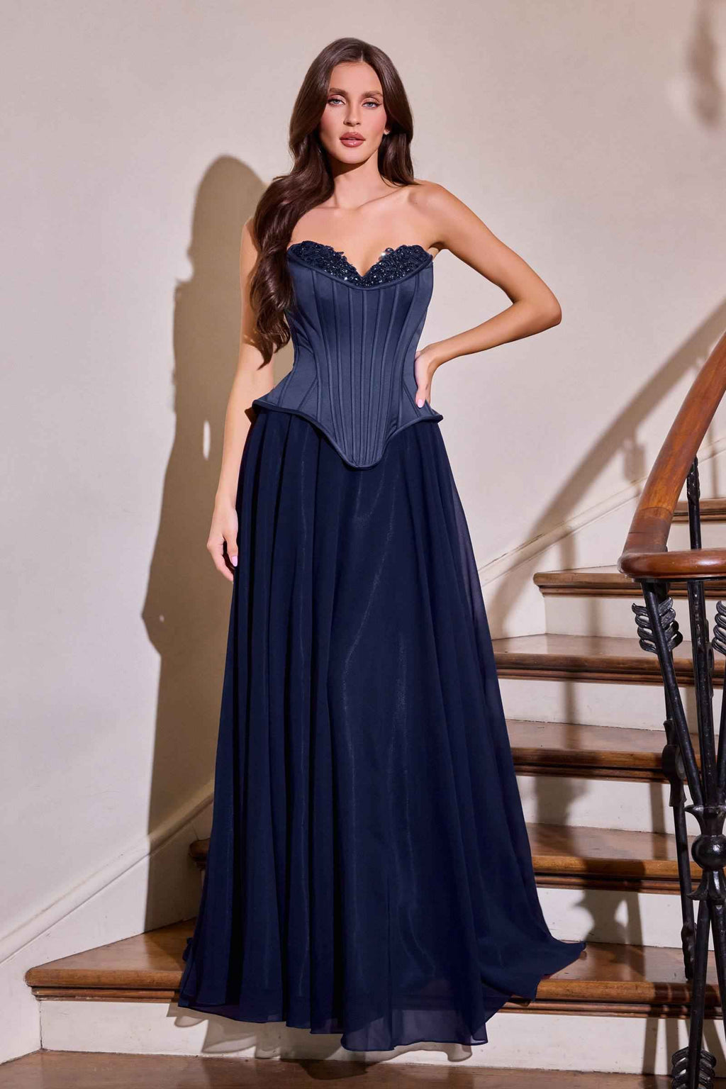 Navy fitted corset bodice gown with sweetheart neckline and flowing chiffon-like skirt