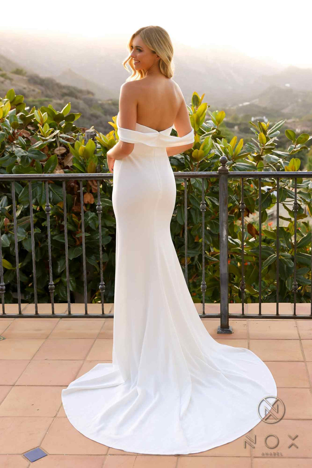 White long off-shoulder fitted gown with flowing mermaid skirt and side slit