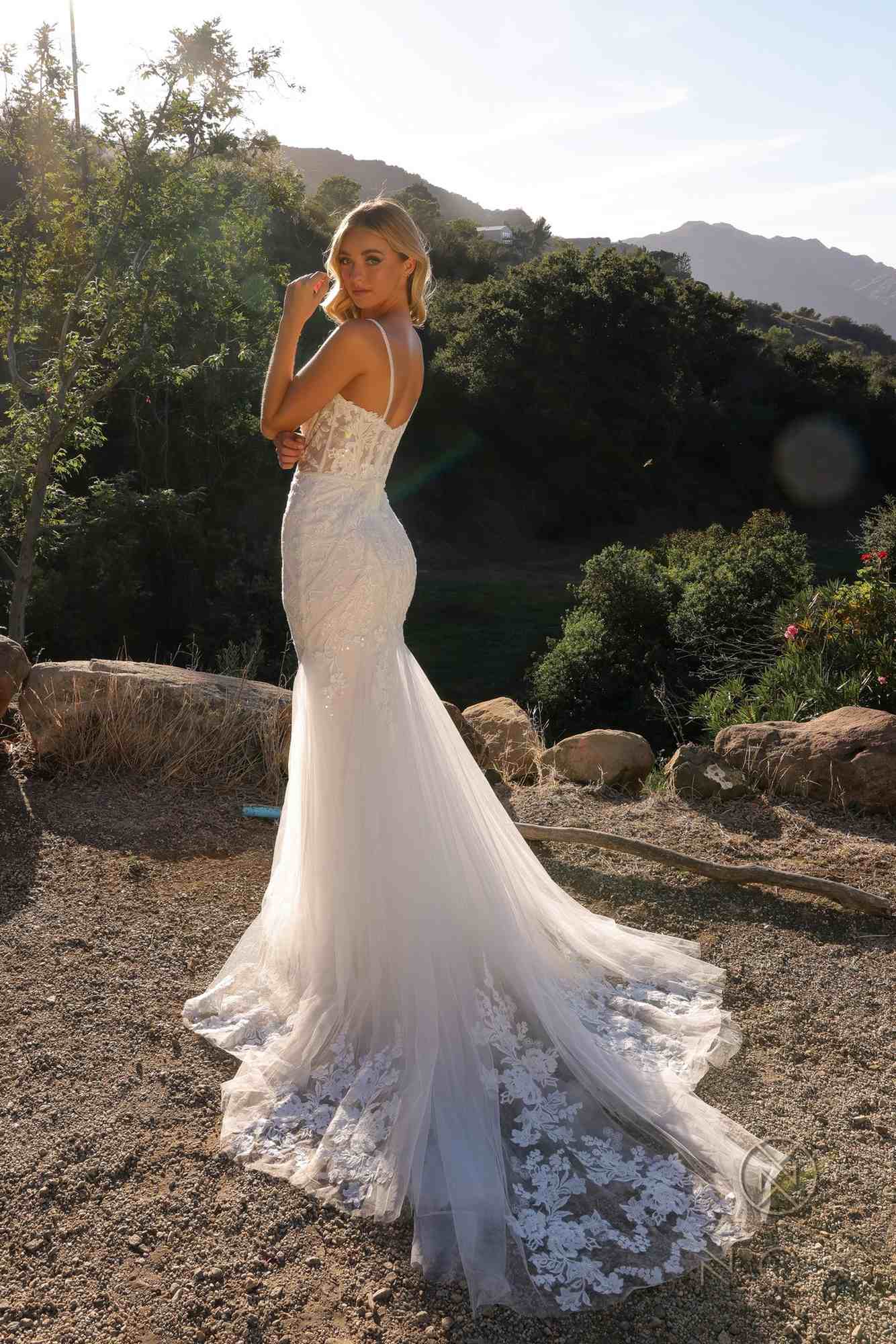White sleeveless mermaid bridal dress, side view, lace applique and long flared hem
