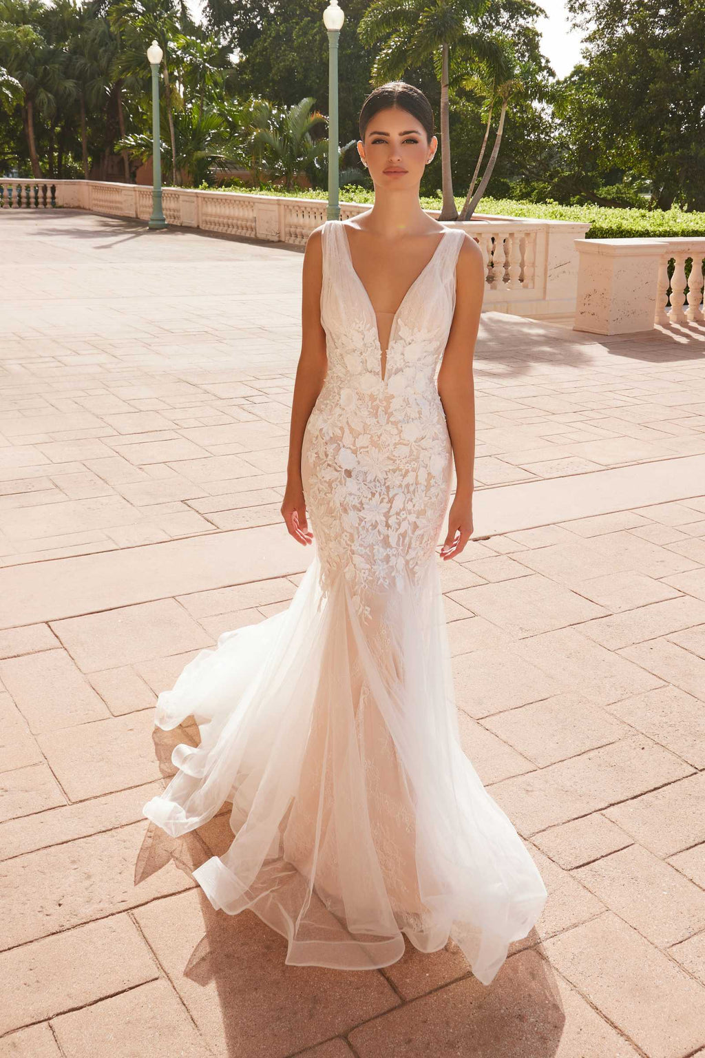 White V-neck mermaid wedding dress with lace detailing and layered tulle skirt