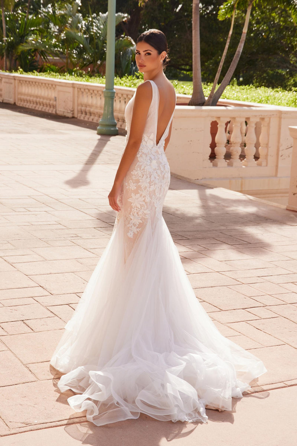 White V-neck mermaid wedding dress with lace bodice and ruffled tulle hem