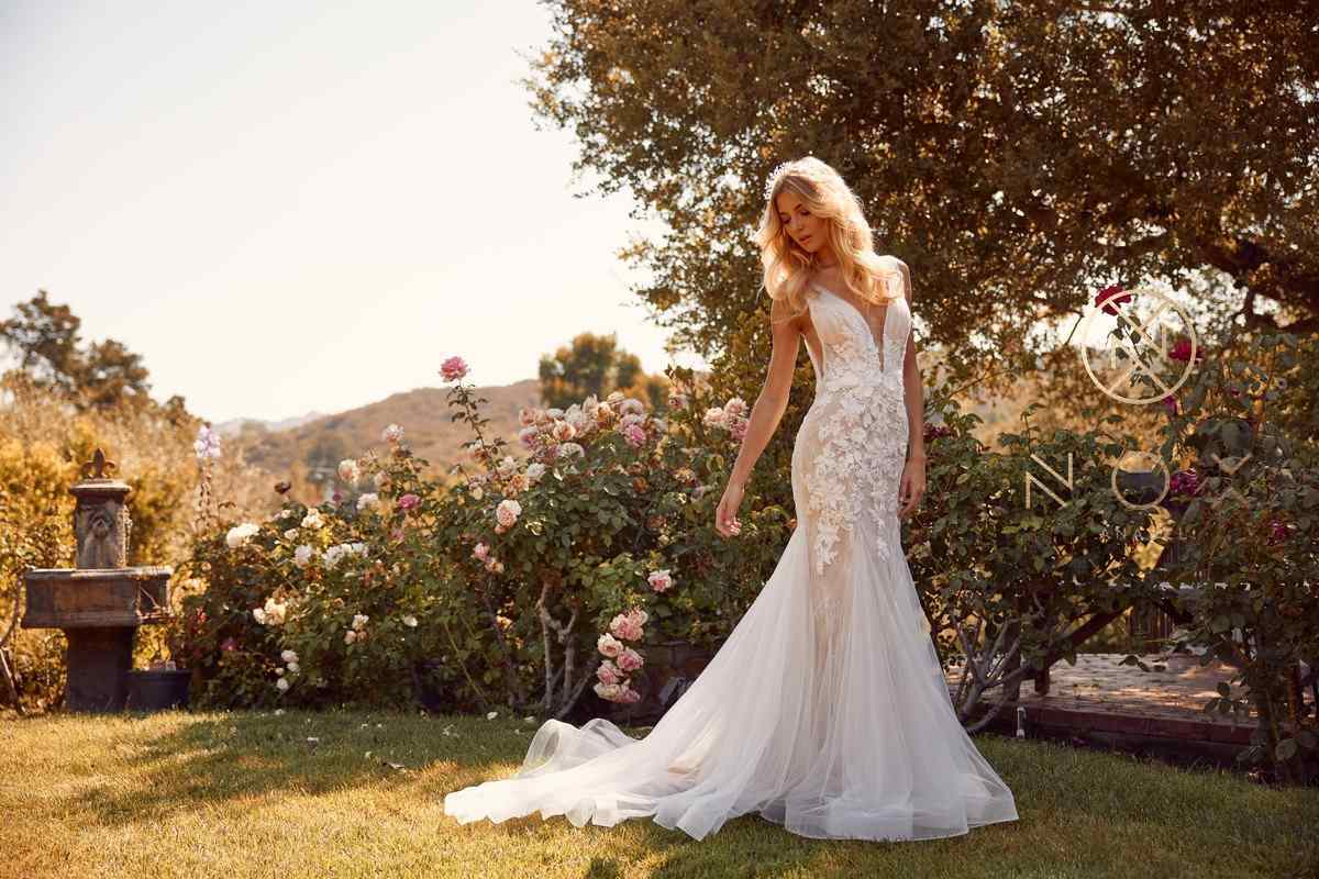 White V-neck lace mermaid wedding dress with flowing tulle skirt in outdoor light