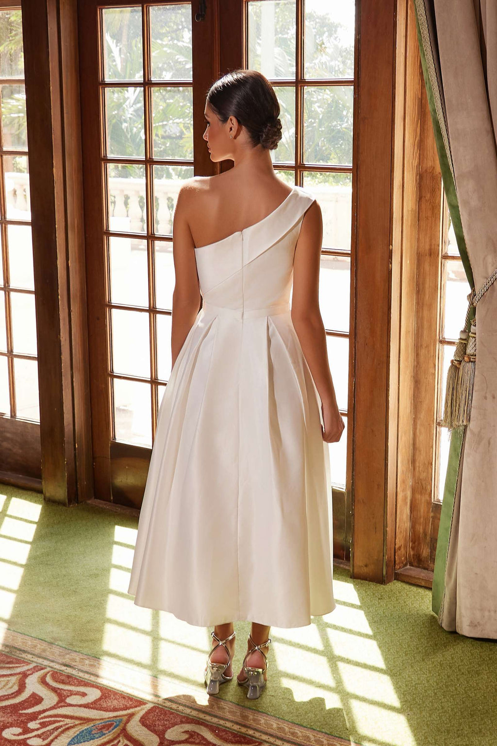 White one-shoulder satin tea-length gown, back view with smooth fitted waist