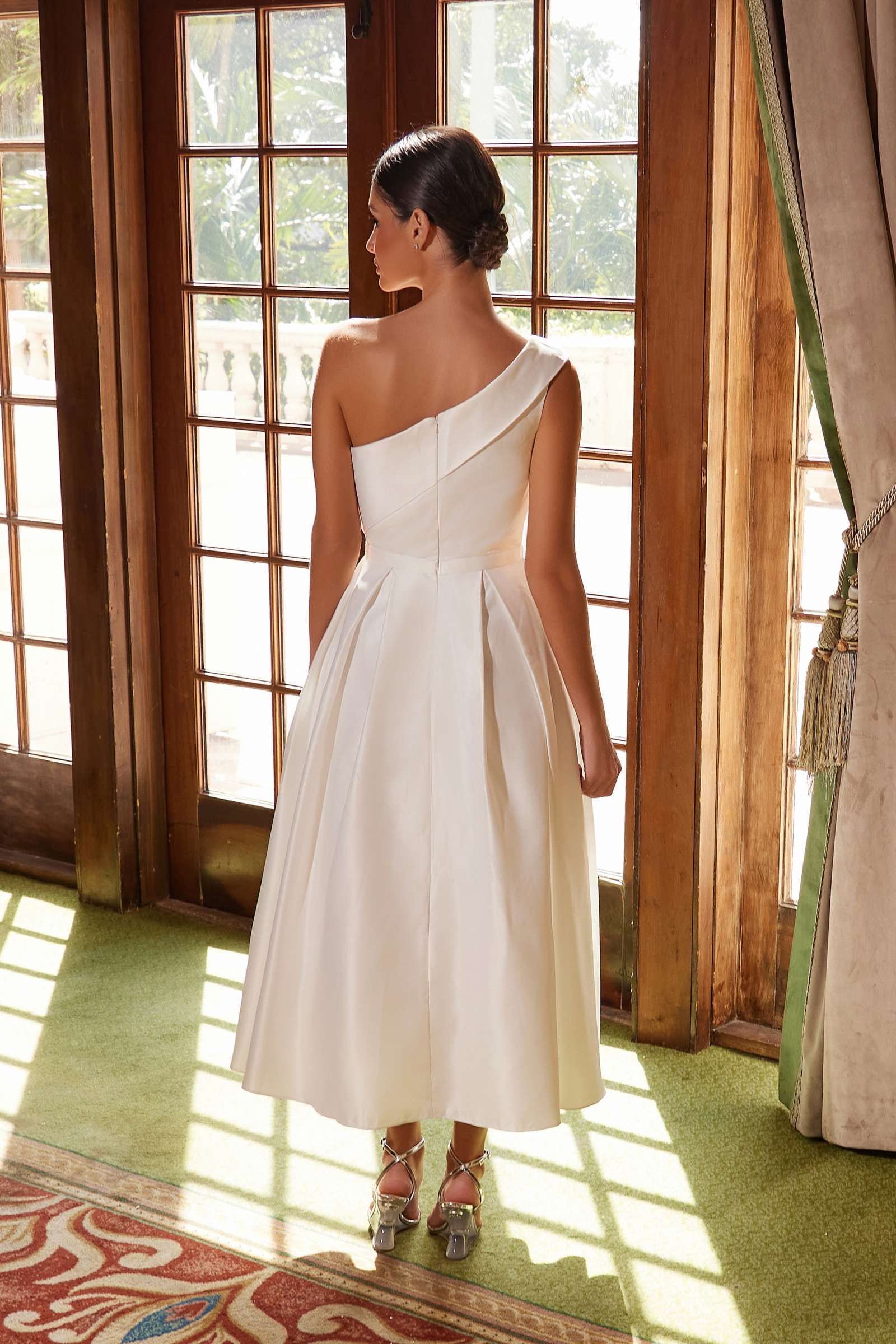 White one-shoulder satin tea-length gown, back view with smooth fitted waist