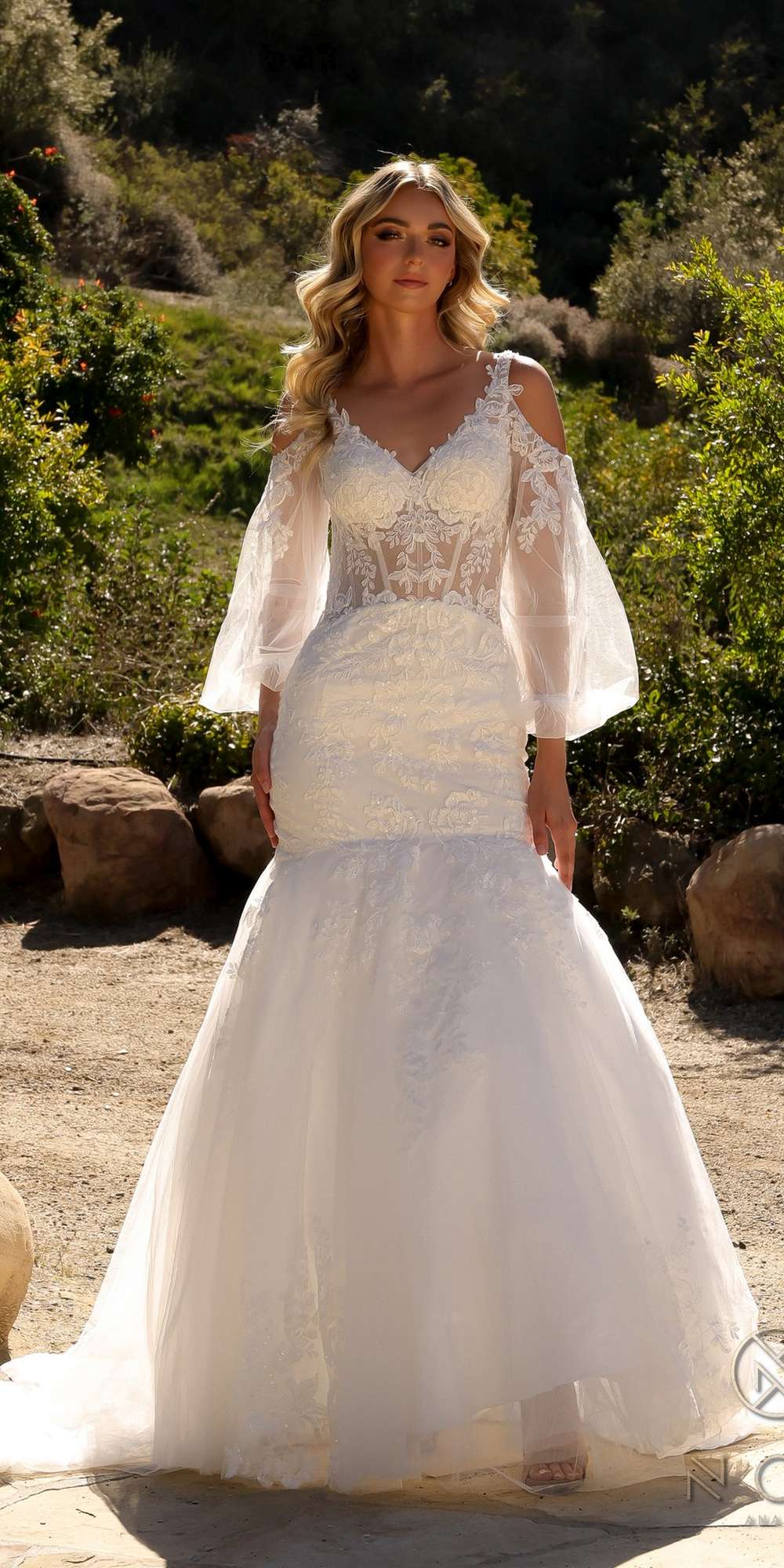 White lace mermaid bridal gown with V-neck bodice and long bell sleeves