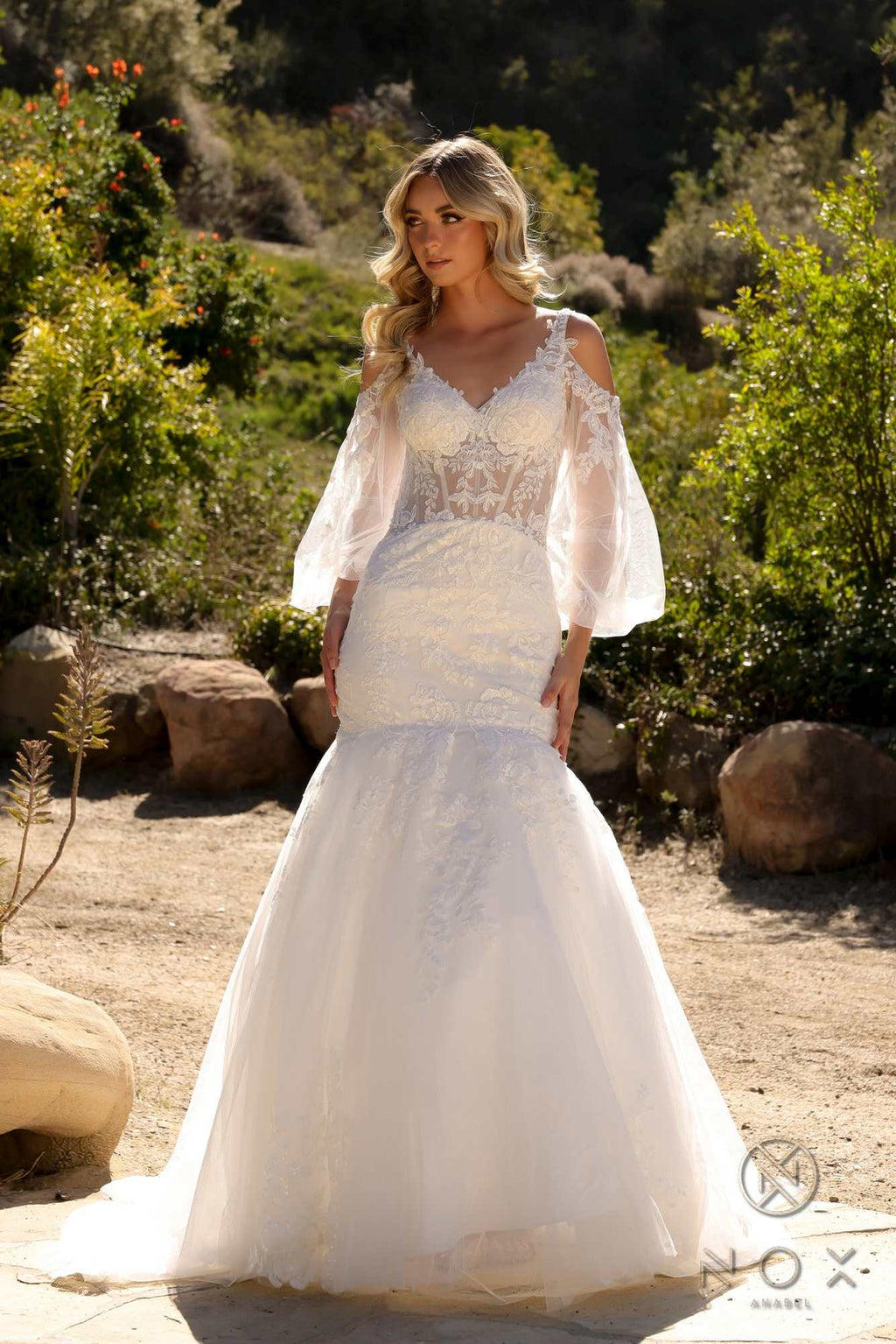 White mermaid bridal gown with lace bodice and long bell sleeves, flowing hem