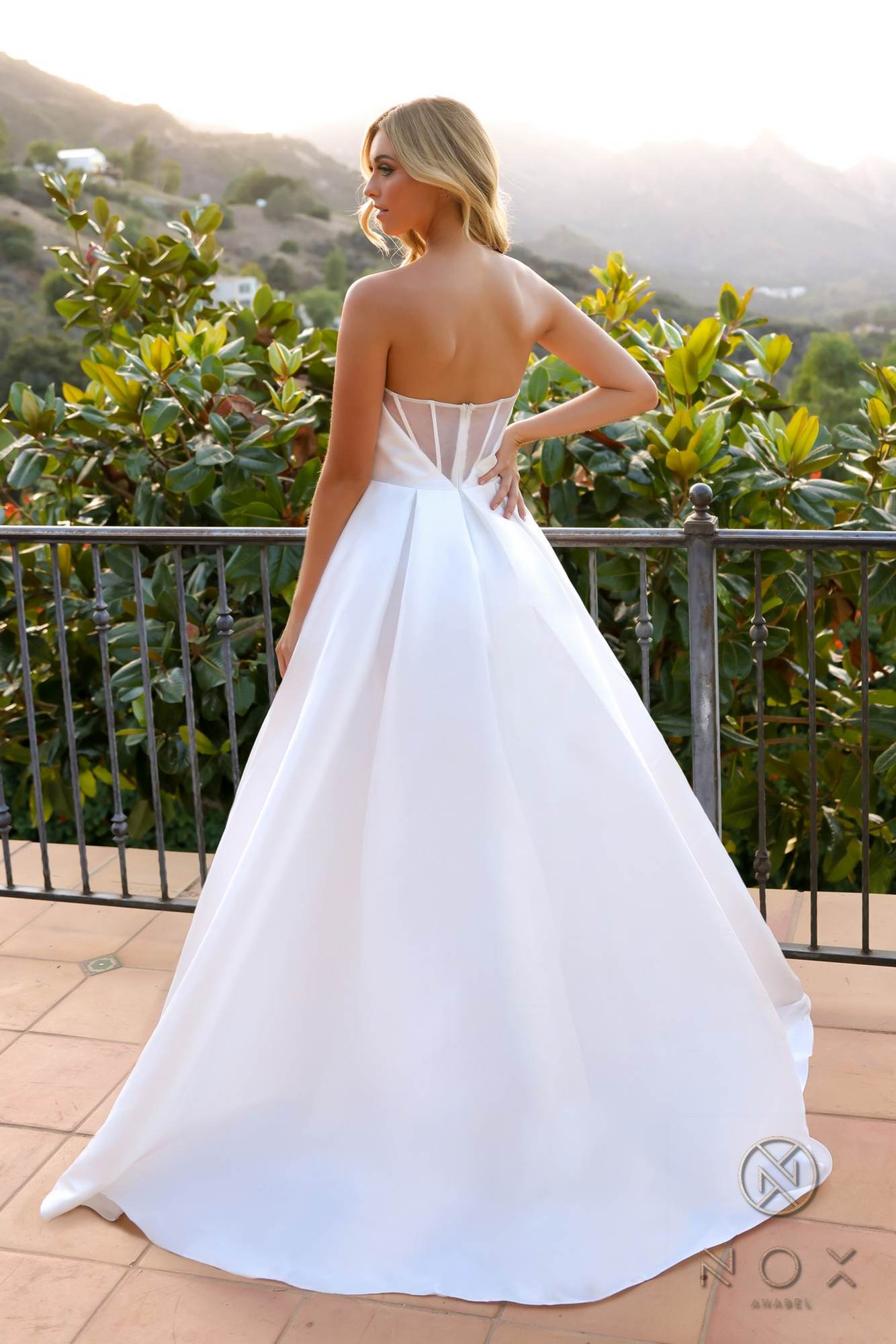 White strapless corset A-line wedding gown, back view with full skirt