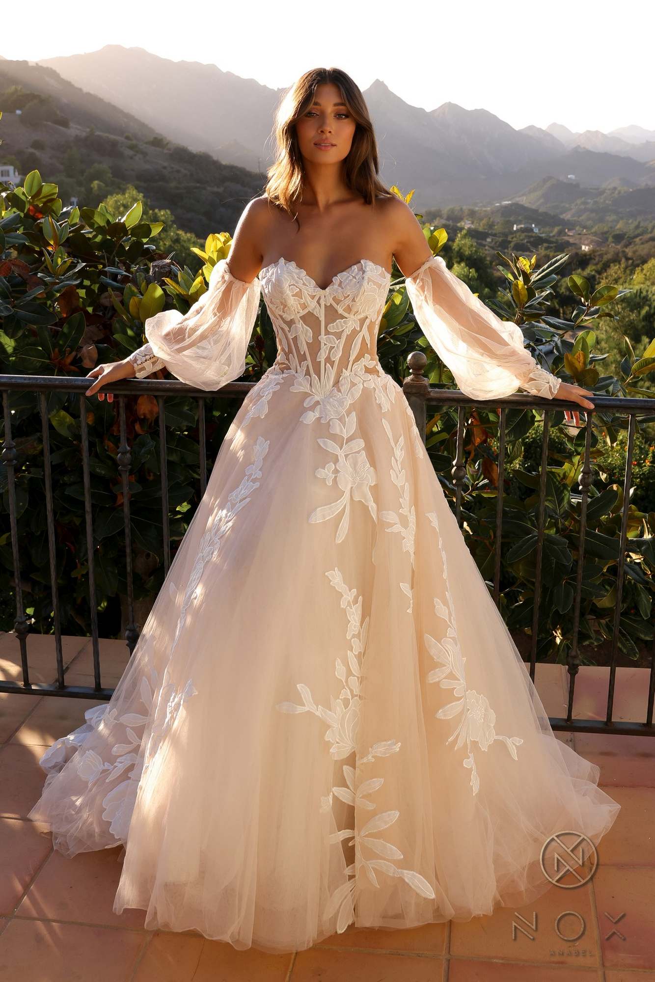 White strapless corset A-line bridal gown with long puff sleeves and embroidered floral overlay