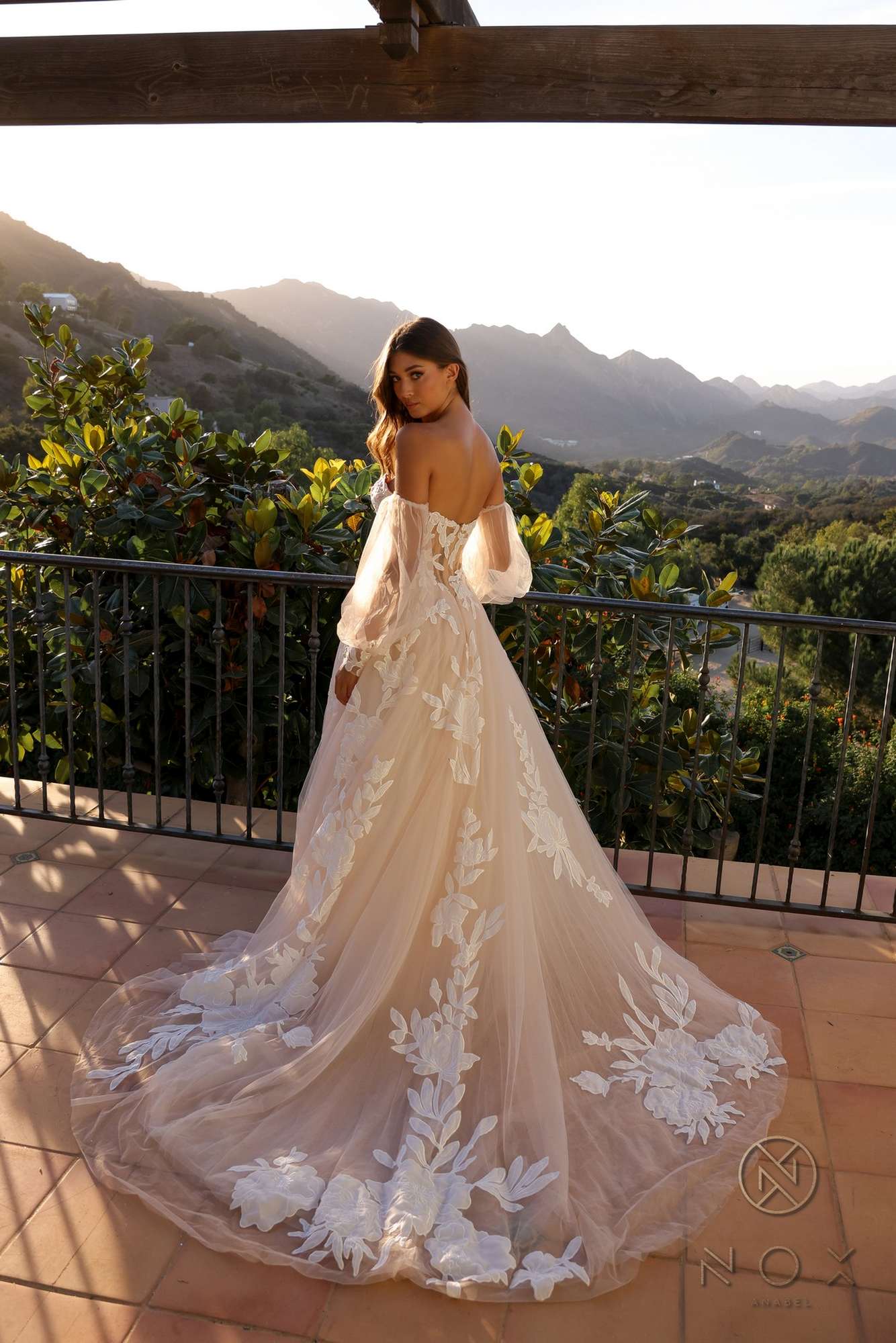 White A-line bridal gown with strapless corset back and floral appliqué skirt
