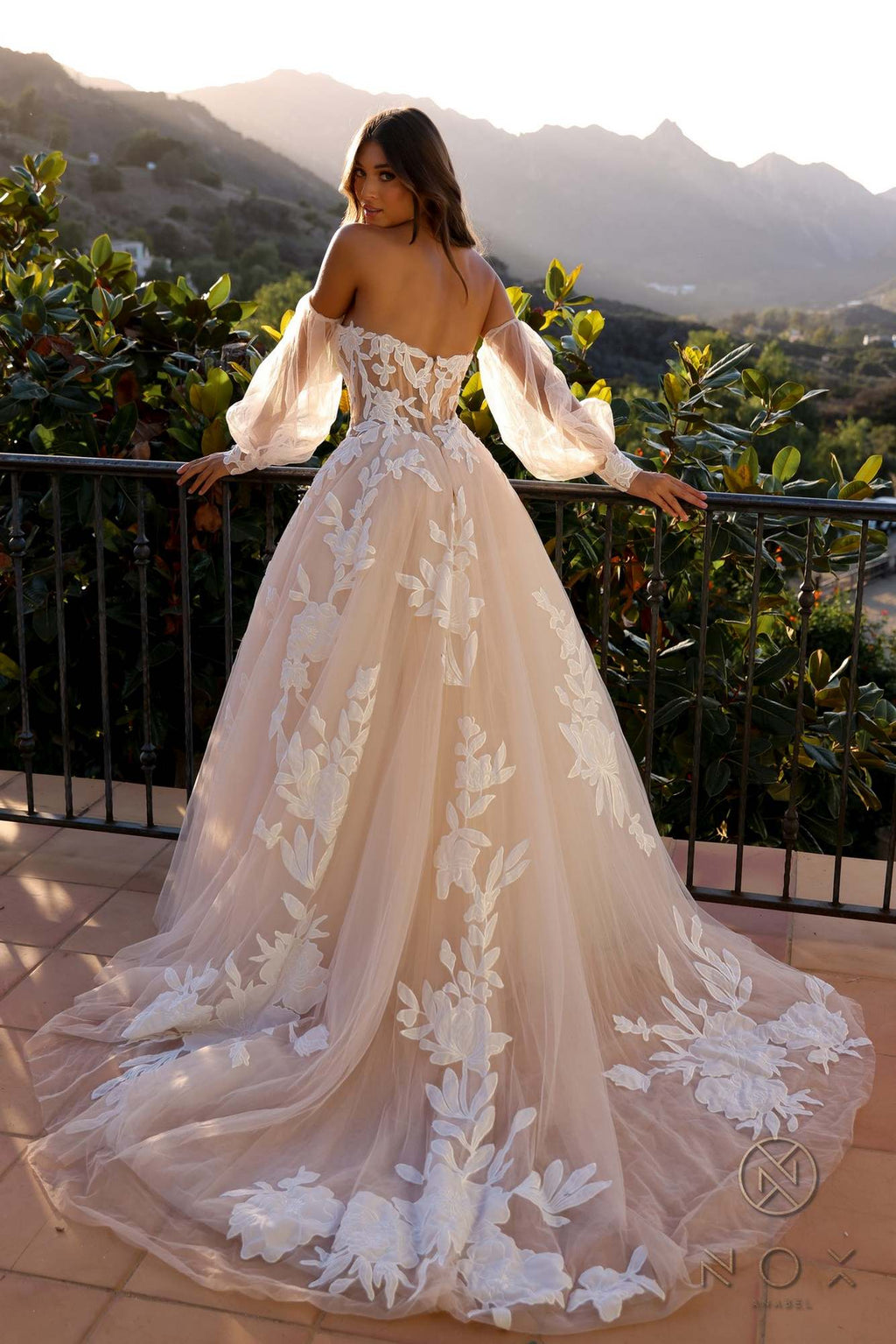 White A-line bridal gown with strapless bodice, long puff sleeves, and floral lace