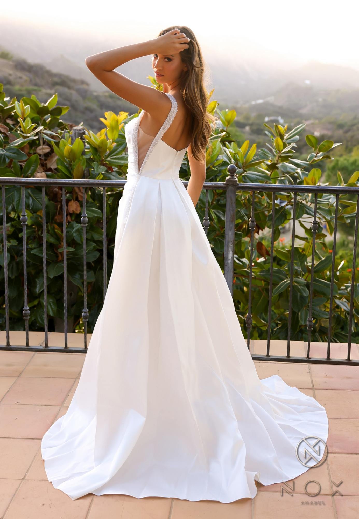 White long sleeveless A-line wedding gown with open back and thin straps